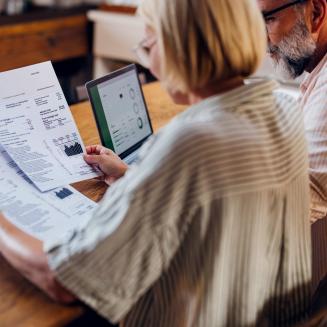 Two people review an energy bill together.