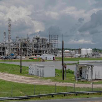 A industrial area with silos and smokestacks.